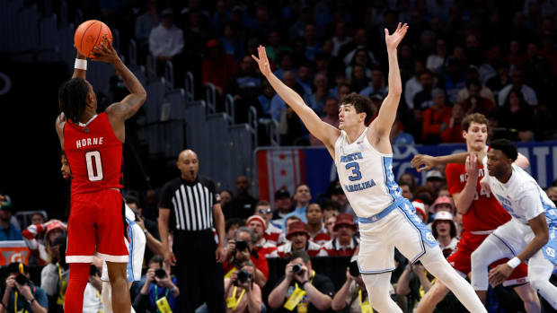 Mar 16, 2024; Washington, D.C., USA; North Carolina State Wolfpack guard DJ Horne (0) shoots the ball agaisnt North Carolina Tar Heels guard Cormac Ryan (3) during the second half at Capital One Arena.